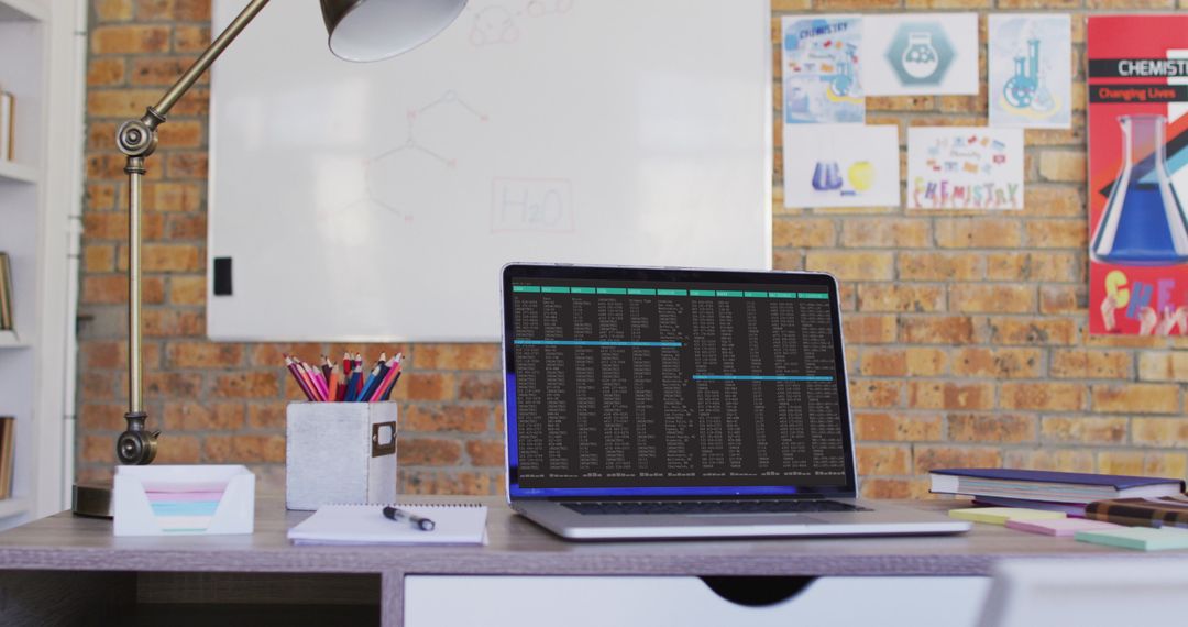 Laptop Displaying Data on Desk in Modern Home Office