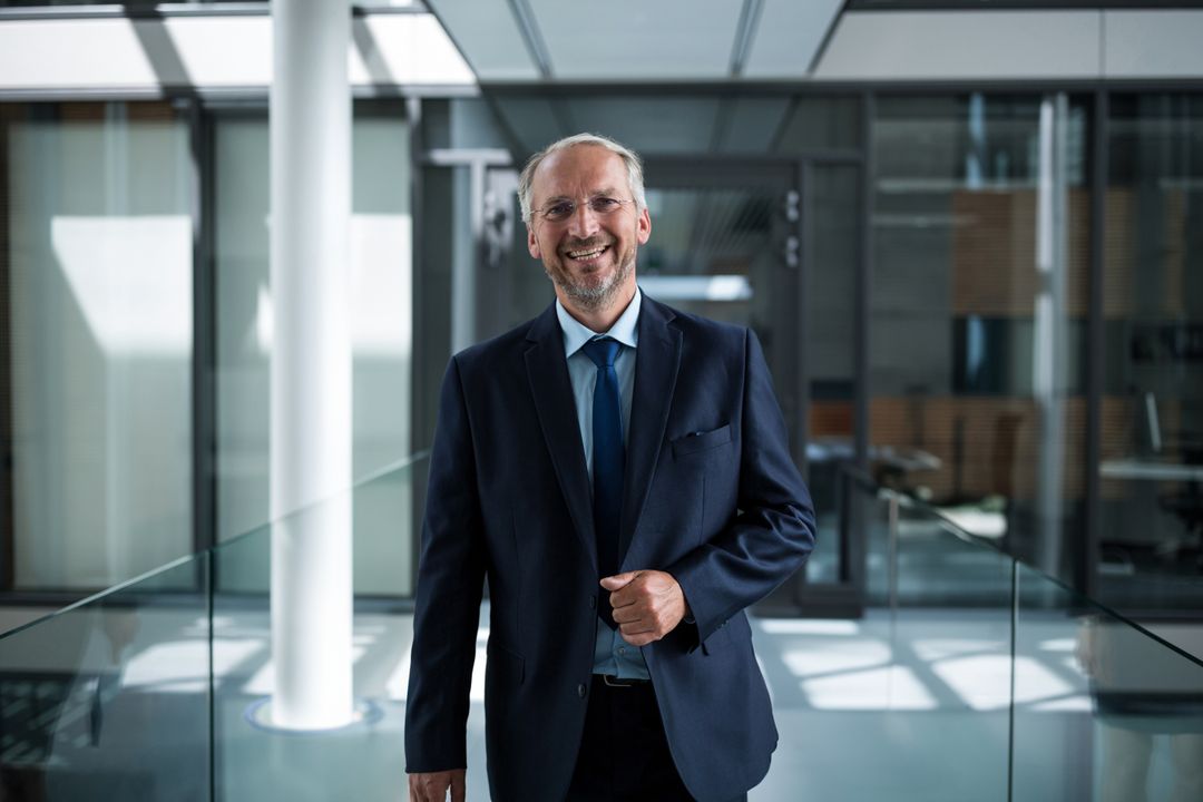 Modern Corporate Environment with Smiling Professional Colleague