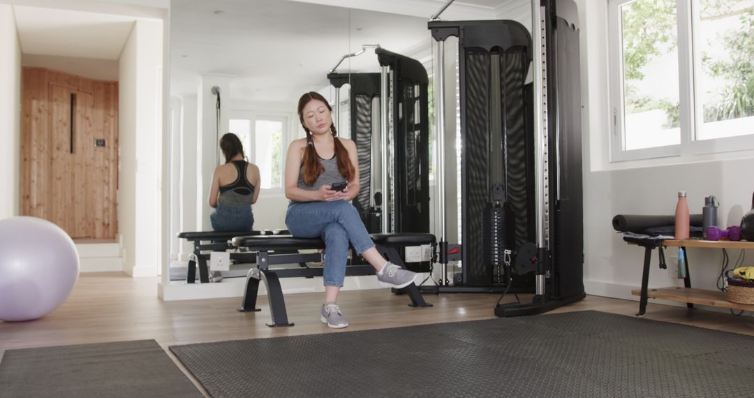 Woman Enjoying Gym Break Chatting on Smartphone