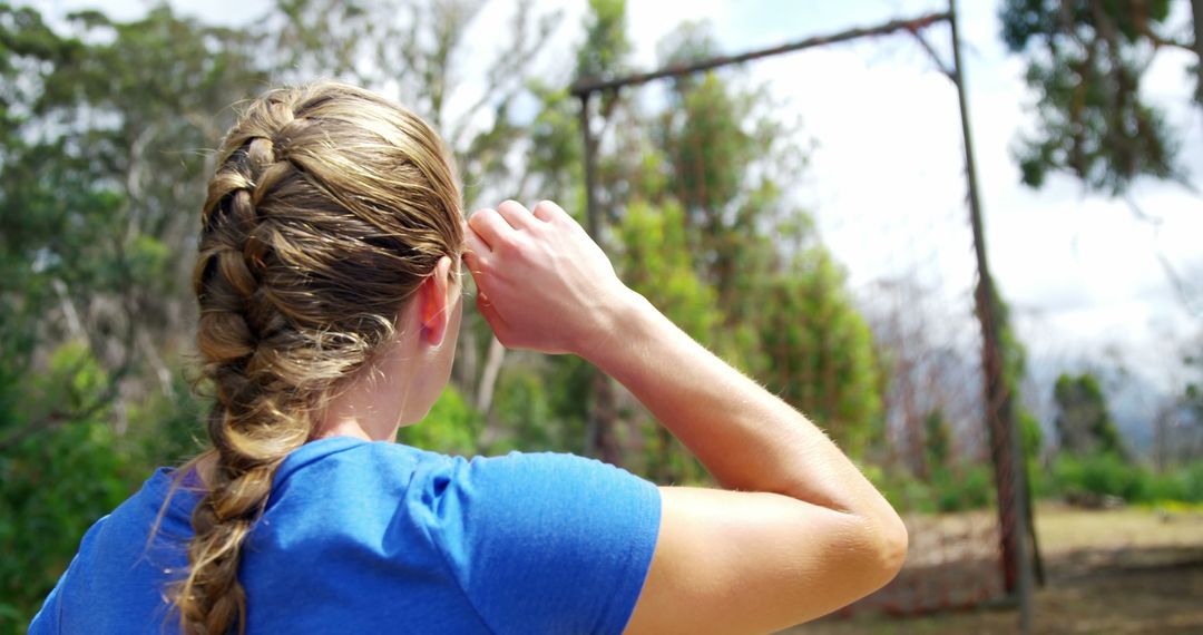 Woman Prepares for Outdoor Activity with Braided Hairstyle Highlight - Free Images, Stock Photos and Pictures on Pikwizard.com