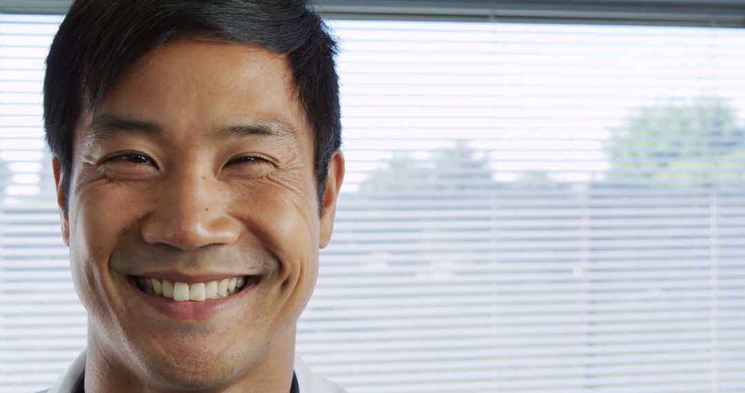 Smiling Asian Healthcare Worker in Professional Setting