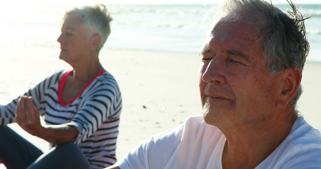 Senior couple practicing meditation on beach at sunrise - Free Images, Stock Photos and Pictures on Pikwizard.com