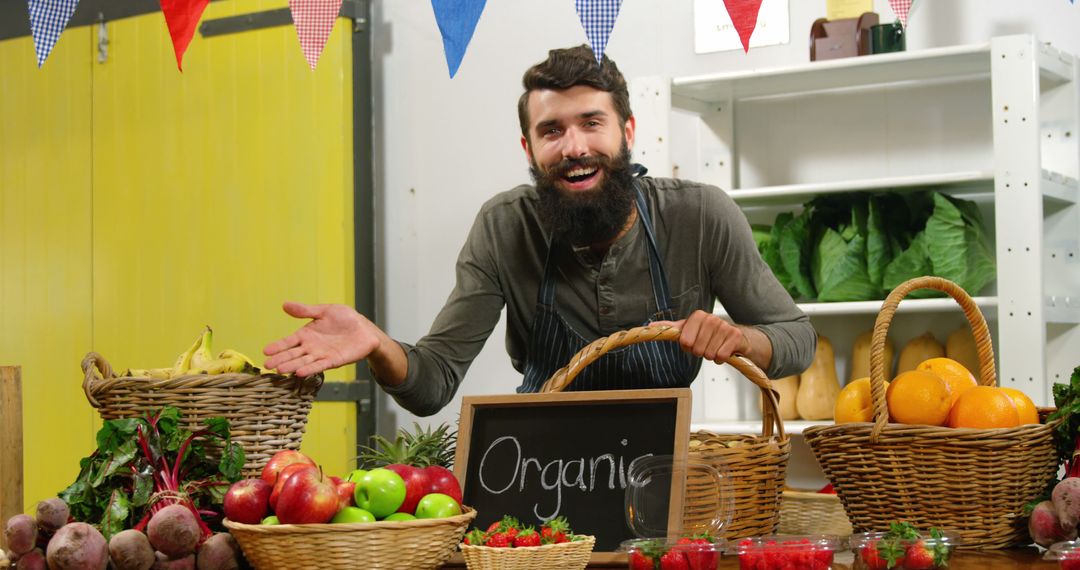 Friendly Vendor Displaying Fresh Organic Produce in Supermarket - Free Images, Stock Photos and Pictures on Pikwizard.com