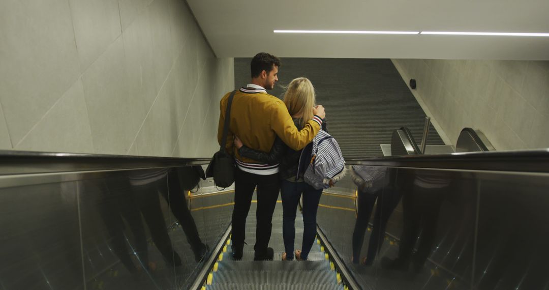 Couple Hugging on Escalator in Modern Building - Free Images, Stock Photos and Pictures on Pikwizard.com