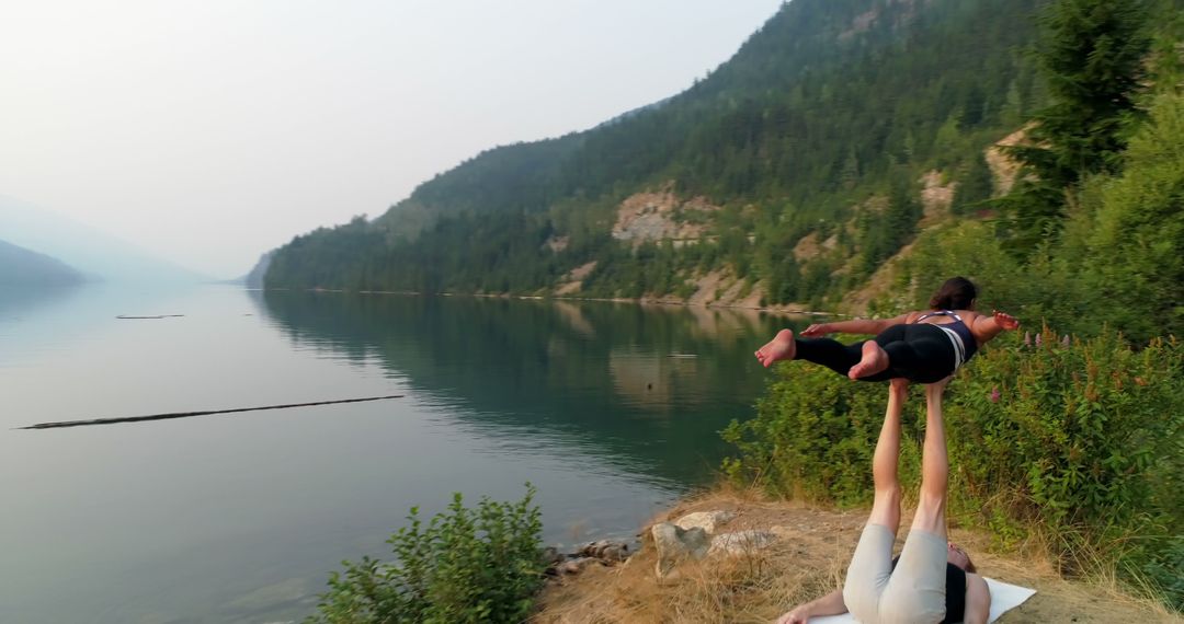 Couple Practicing Acro Yoga Near Mountain Lake - Free Images, Stock Photos and Pictures on Pikwizard.com