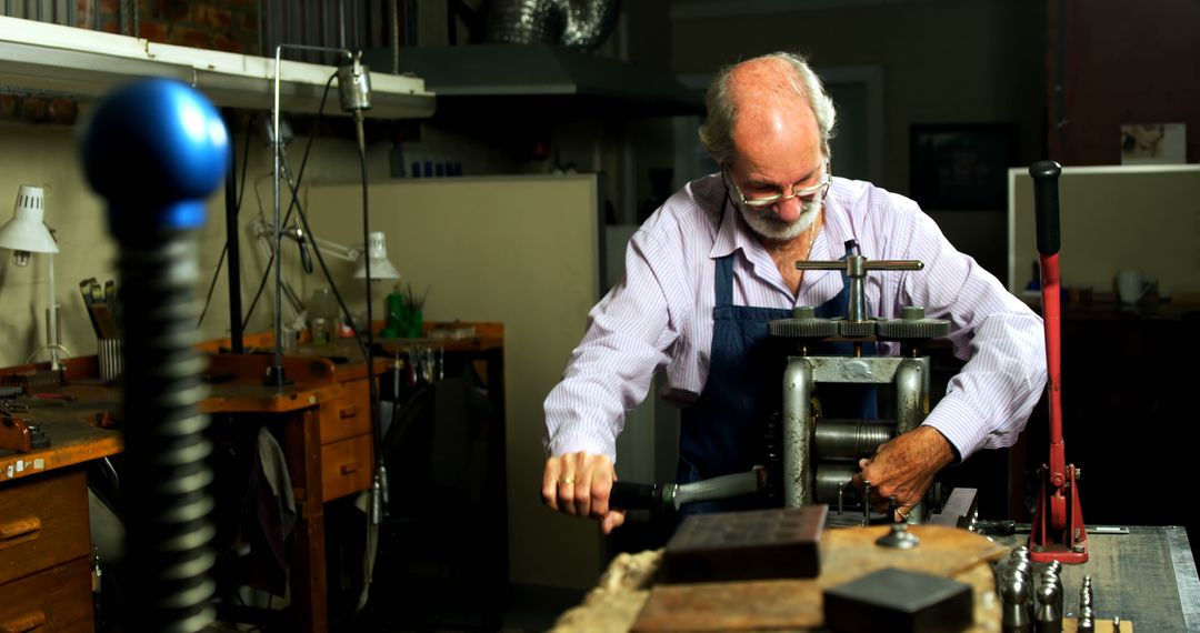 Elderly craftsman using machinery in workshop - Free Images, Stock Photos and Pictures on Pikwizard.com