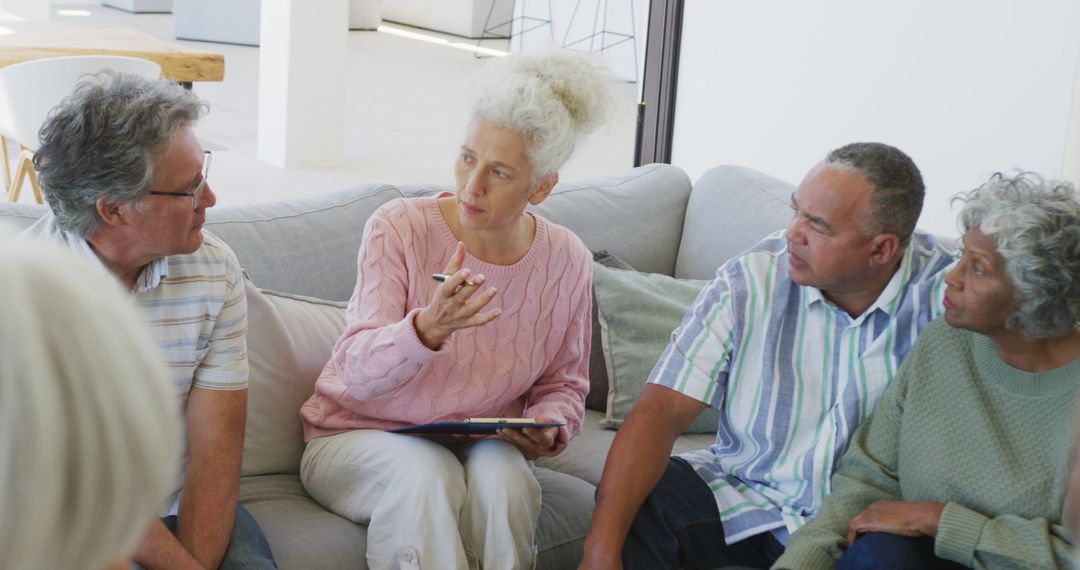 Senior Adults Having Group Discussion in a Bright Living Room - Free Images, Stock Photos and Pictures on Pikwizard.com