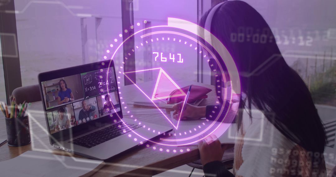 Middle Eastern Teen in Hijab Writing While Attending Virtual Class on Laptop at Home Desk