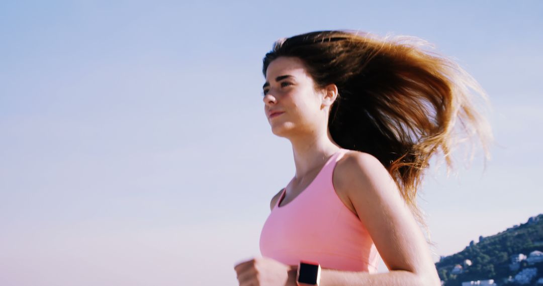 Young Woman Jogging Outdoors with Determination - Free Images, Stock Photos and Pictures on Pikwizard.com