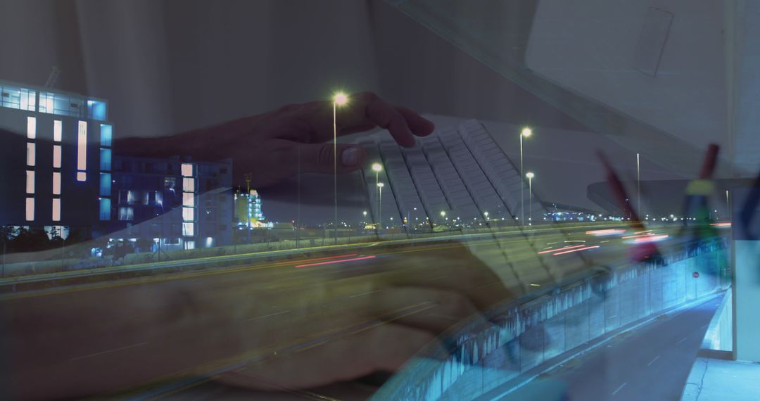 Hands on Laptop Overlaid on Fast-Paced City Traffic Scene at Night