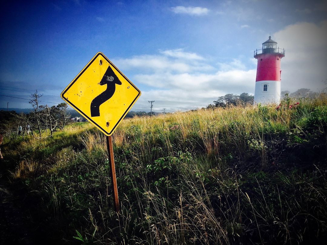 Rustic Pathway Near Historic Red and White Lighthouse