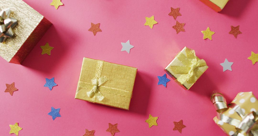 Golden Gift Boxes and Colorful Stars on Pink Background - Free Images, Stock Photos and Pictures on Pikwizard.com
