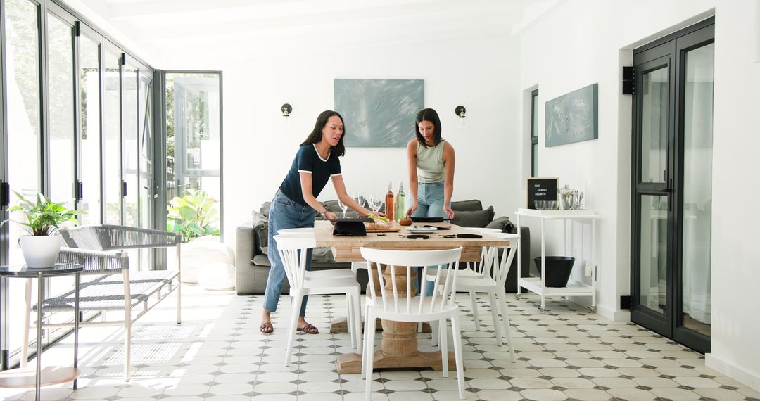 Friends Preparing Dining Table for Graduation Celebration