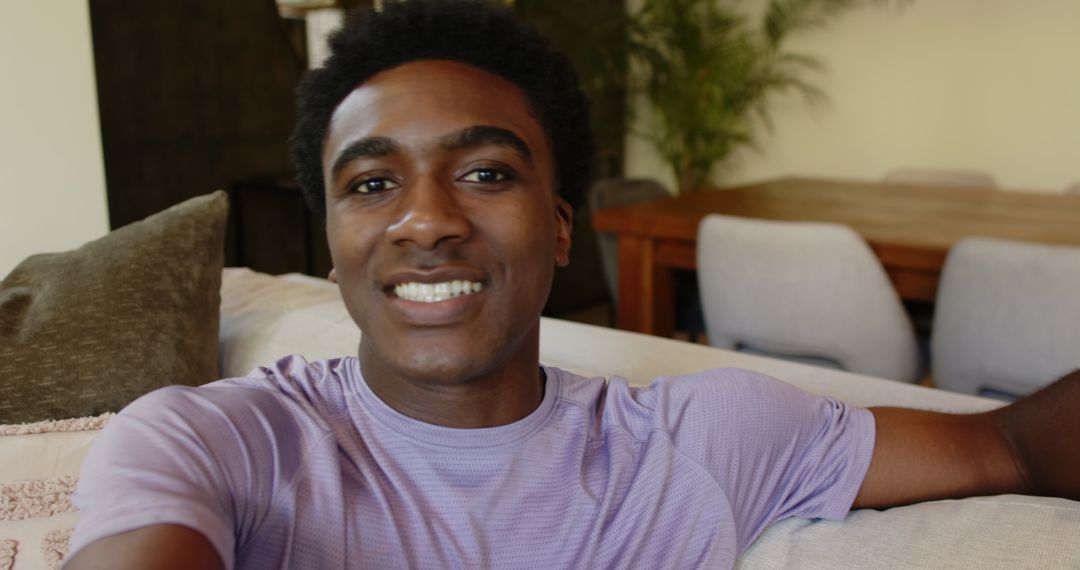 Smiling Man Relaxing on Cozy Sofa in Contemporary Living Room