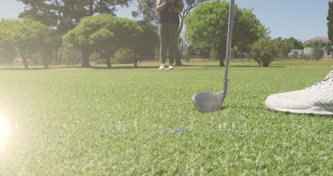 Golf Player Lining Up Shot on Sunny Day at Golf Course