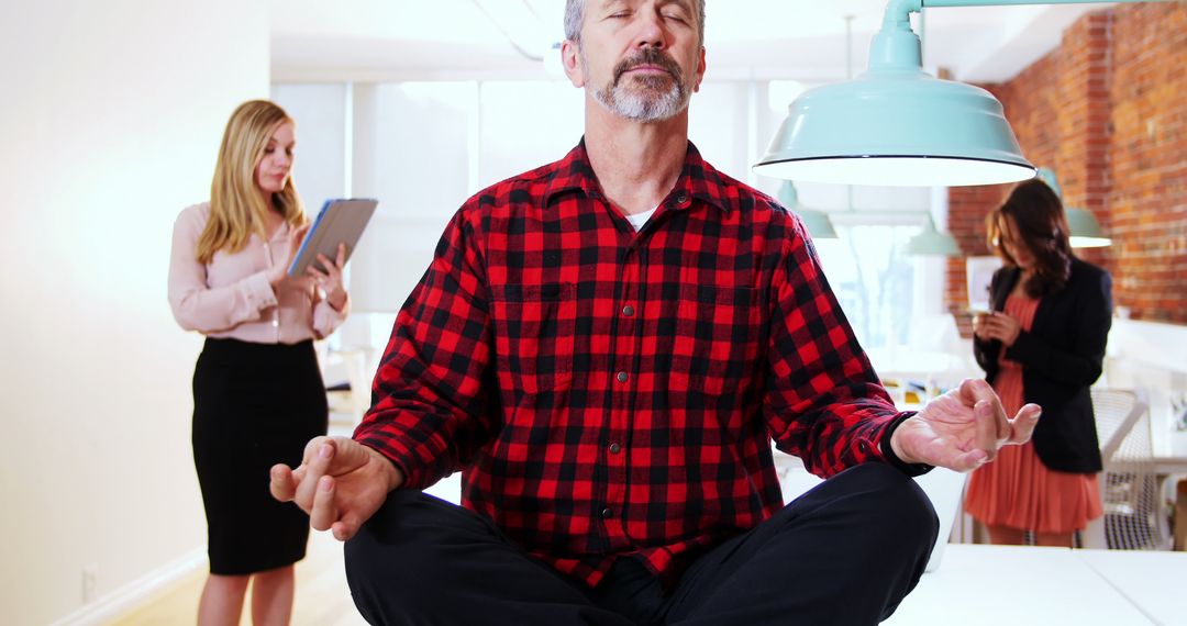 Businessman Meditating in Lotus Position in Modern Office - Free Images, Stock Photos and Pictures on Pikwizard.com