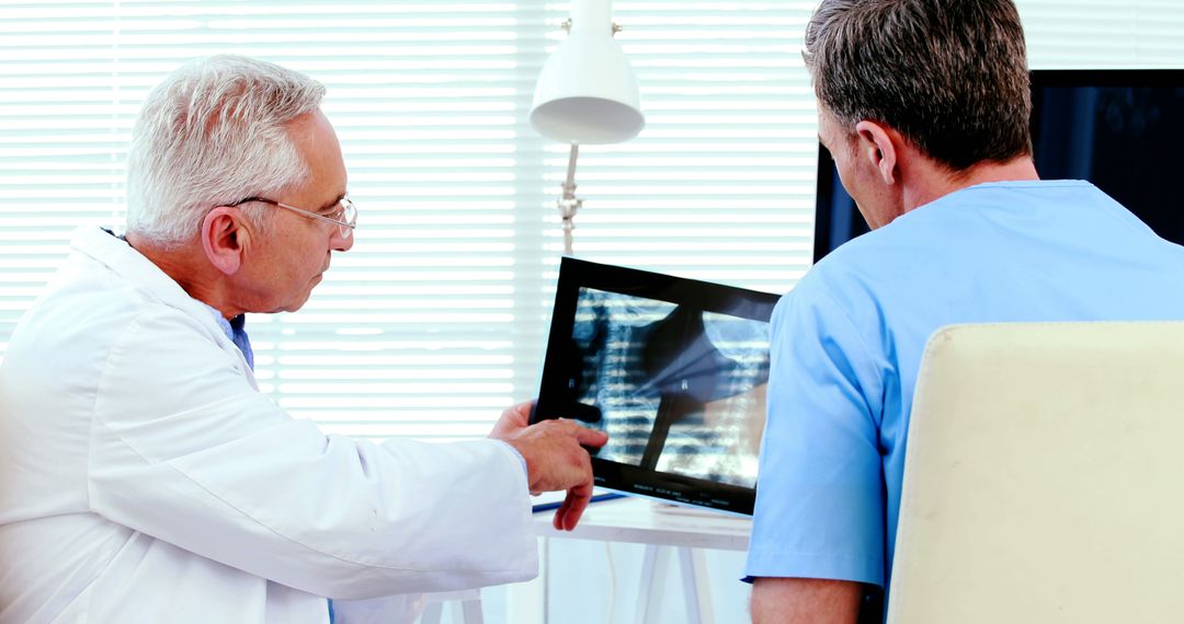 Doctors Analyzing X-ray Images in Medical Office - Free Images, Stock Photos and Pictures on Pikwizard.com