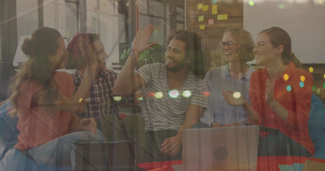 Diverse Team With Financial Graph Overlay Celebrating in Office