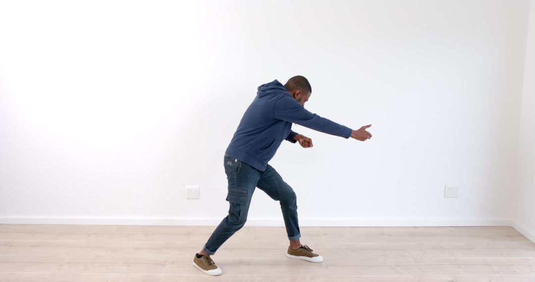 Energetic Male Dancer in Minimalist Room Expressing Creativity