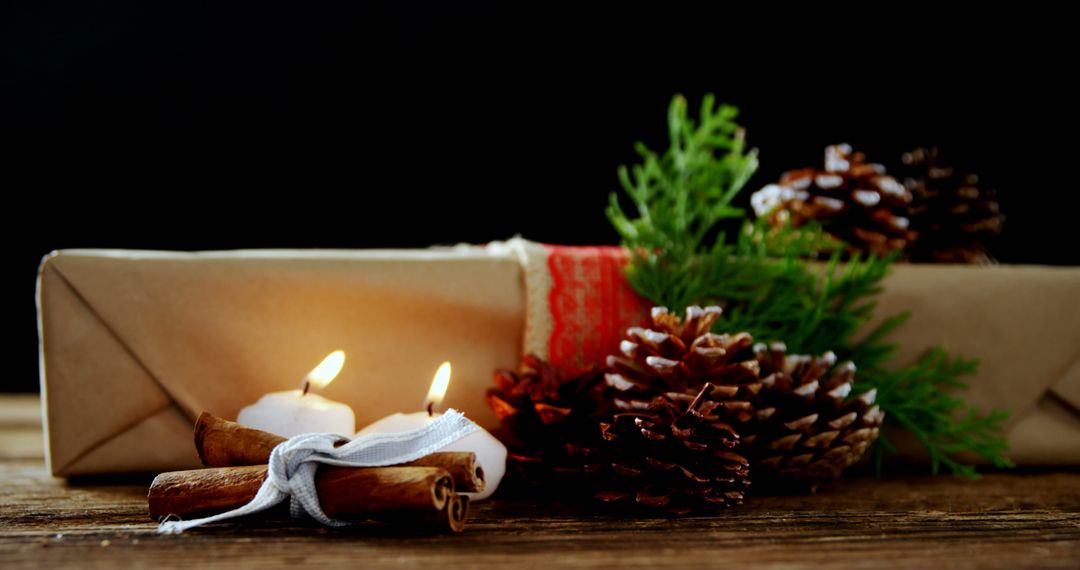 Festive Holiday Gift with Candles and Pine Cones - Free Images, Stock Photos and Pictures on Pikwizard.com