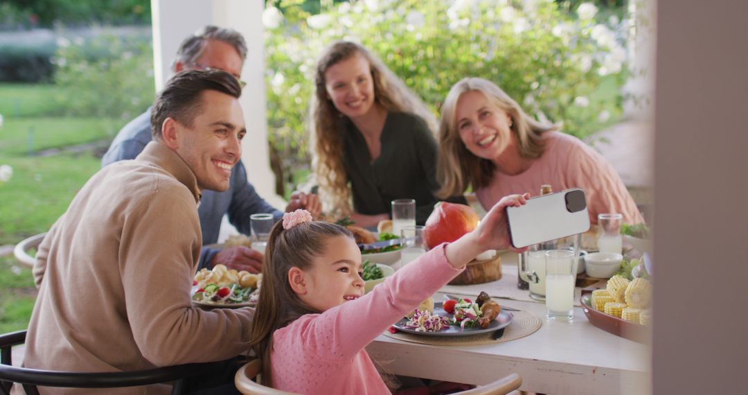 Image of happy caucasian parents, daughter and grandparents taking selfie at outdoor dinner table - Free Images, Stock Photos and Pictures on Pikwizard.com