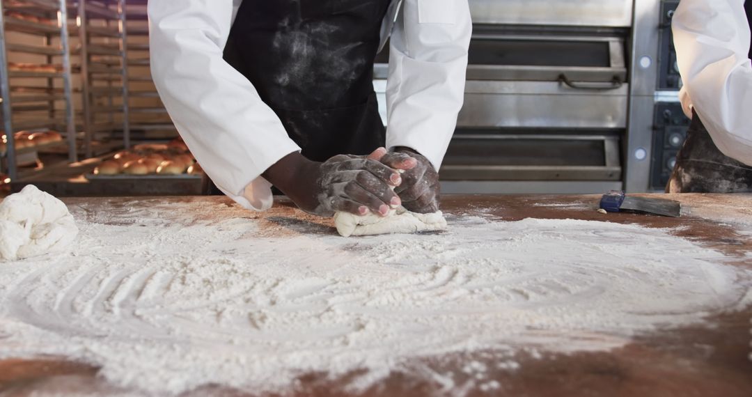 Close-Up of Baker Kneading Dough in Commercial Kitchen - Free Images, Stock Photos and Pictures on Pikwizard.com