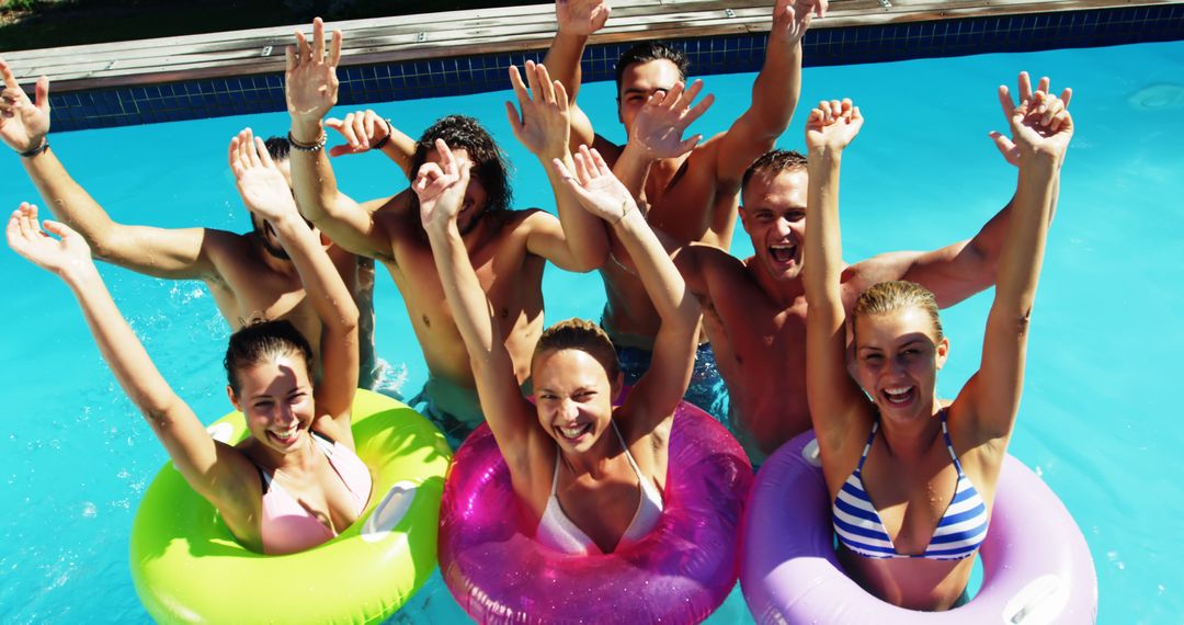 Group of Friends Enjoying Pool Time with Inflatable Rings on Summer Day - Free Images, Stock Photos and Pictures on Pikwizard.com