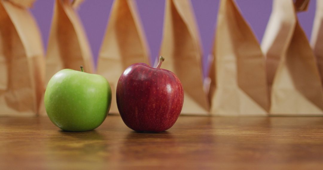 Fresh Apples and Paper Bags on Wooden Table