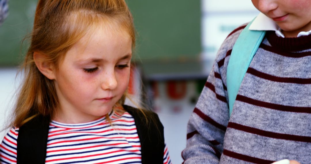 Schoolchildren Engaged with Digital Tablet in Classroom