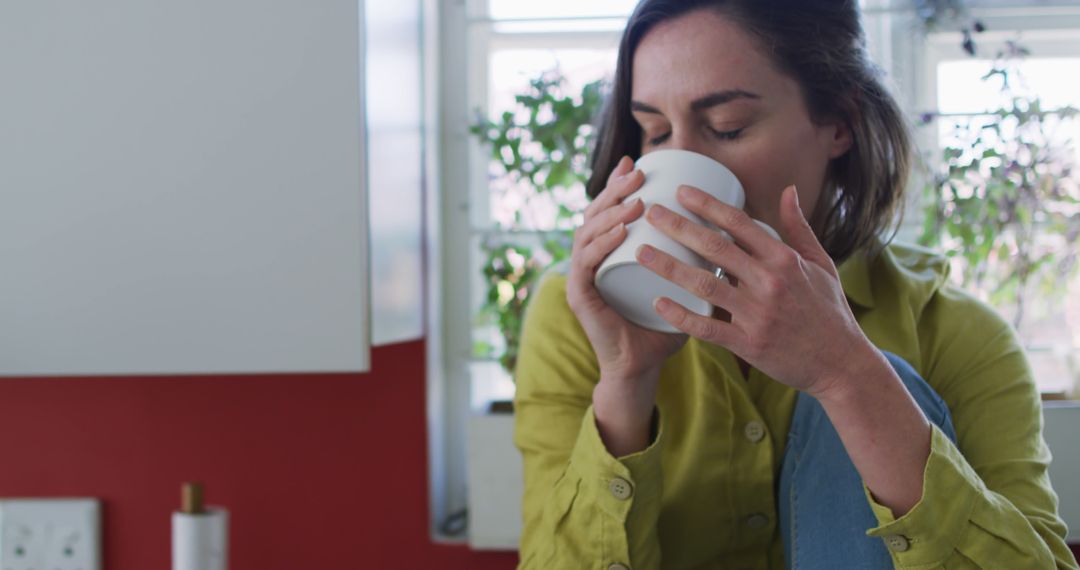 Woman Relaxing at Home Drinking Coffee by Window - Free Images, Stock Photos and Pictures on Pikwizard.com