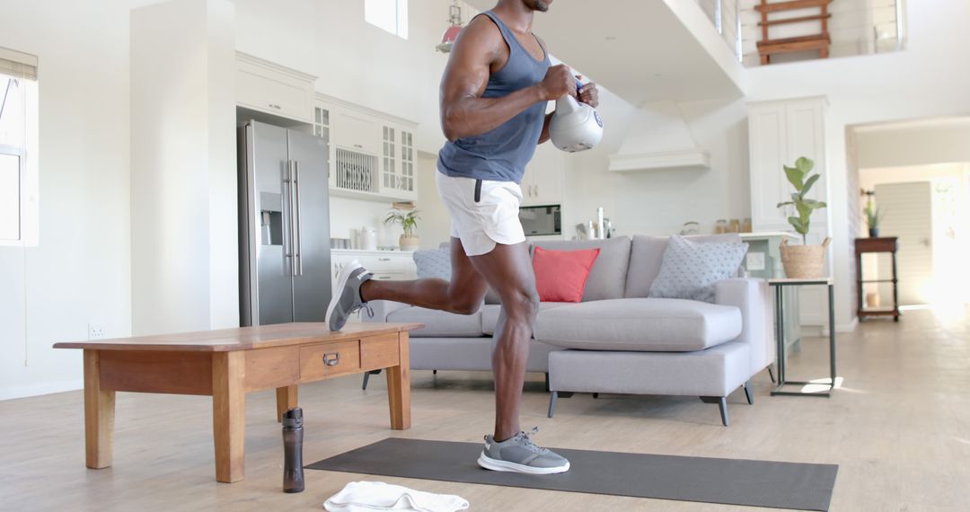 Man Doing Single-Leg Squats While Holding Kettlebell in Home - Free Images, Stock Photos and Pictures on Pikwizard.com