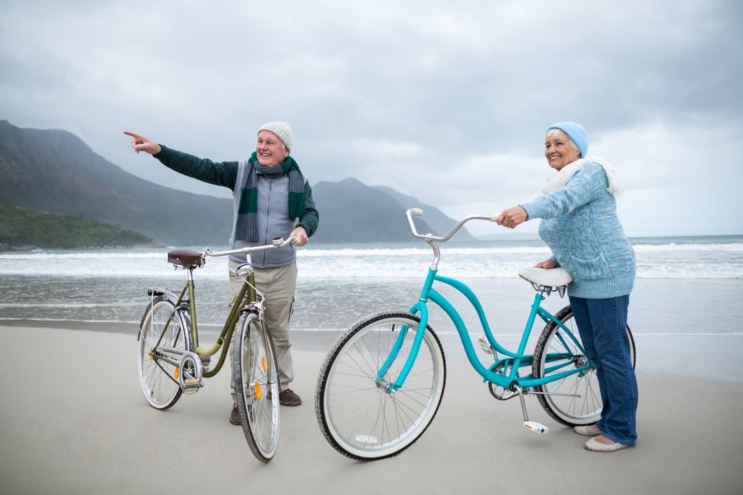 Happy Senior Couple with Bicycles on Beach - Free Images, Stock Photos and Pictures on Pikwizard.com