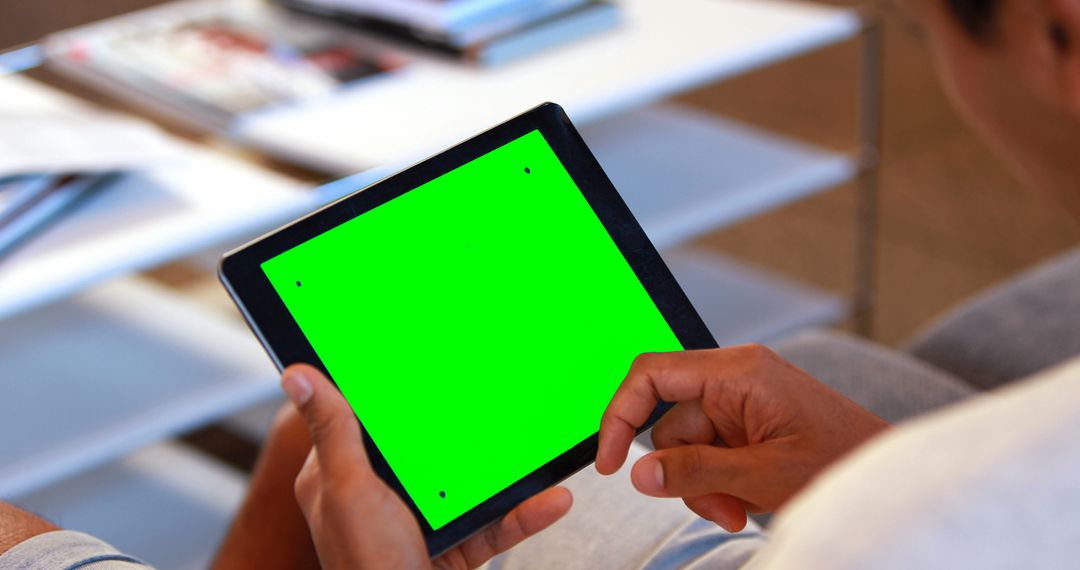 Person Using Tablet with Green Screen in Comfort of Home - Free Images, Stock Photos and Pictures on Pikwizard.com