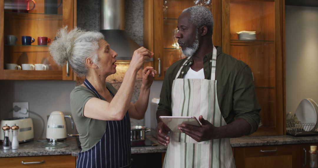 Elderly Couple Enjoying Cooking Together in Modern Kitchen - Free Images, Stock Photos and Pictures on Pikwizard.com