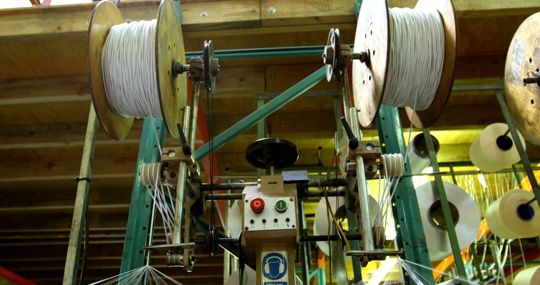 Industrial Textile Machinery with Spools in a Factory - Free Images, Stock Photos and Pictures on Pikwizard.com