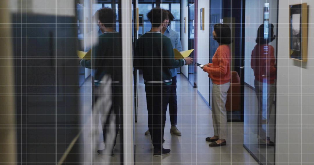 Colleagues Discussing Work in Modern Office Corridor