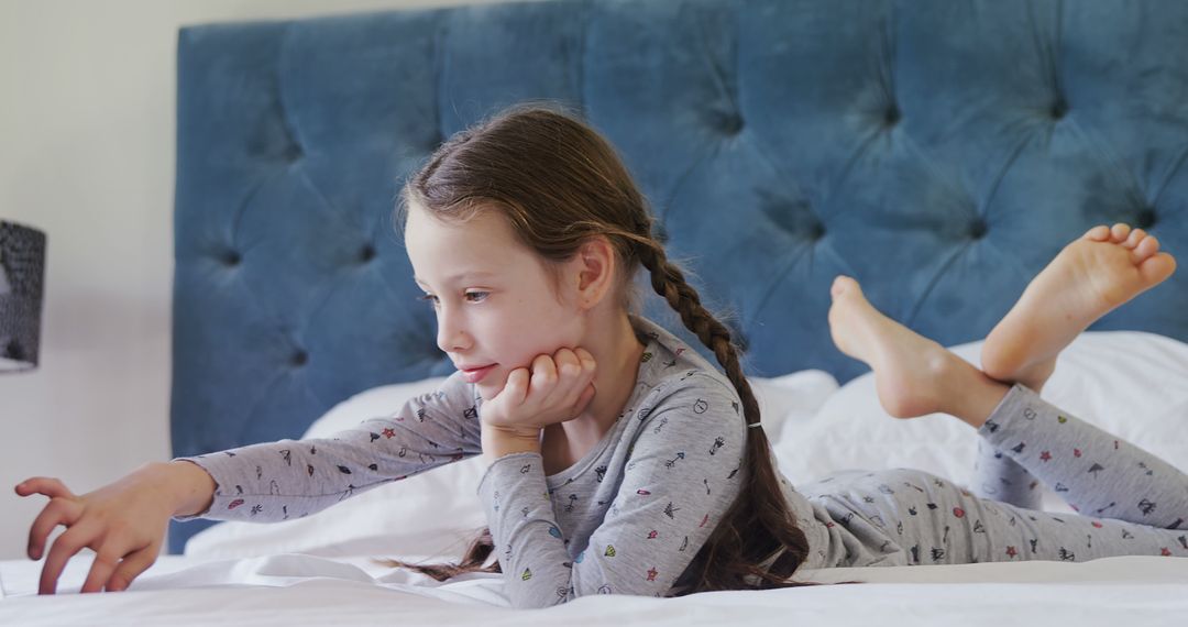 Young Girl Relaxing on Bed in Comfortable Pajamas - Free Images, Stock Photos and Pictures on Pikwizard.com