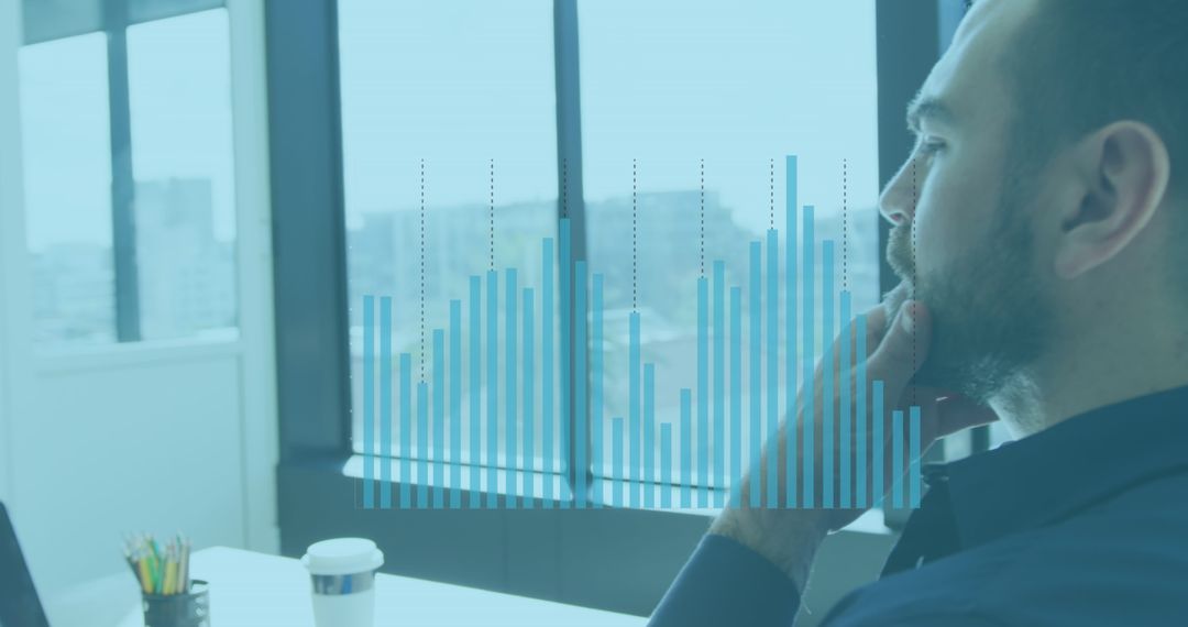 Businessman Analyzing Digital Financial Data in Office Setting