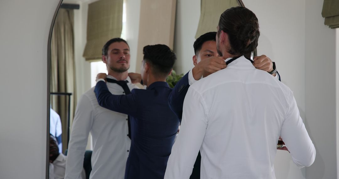 Groomsmen Adjusting Attire in Mirror for Wedding Preparation