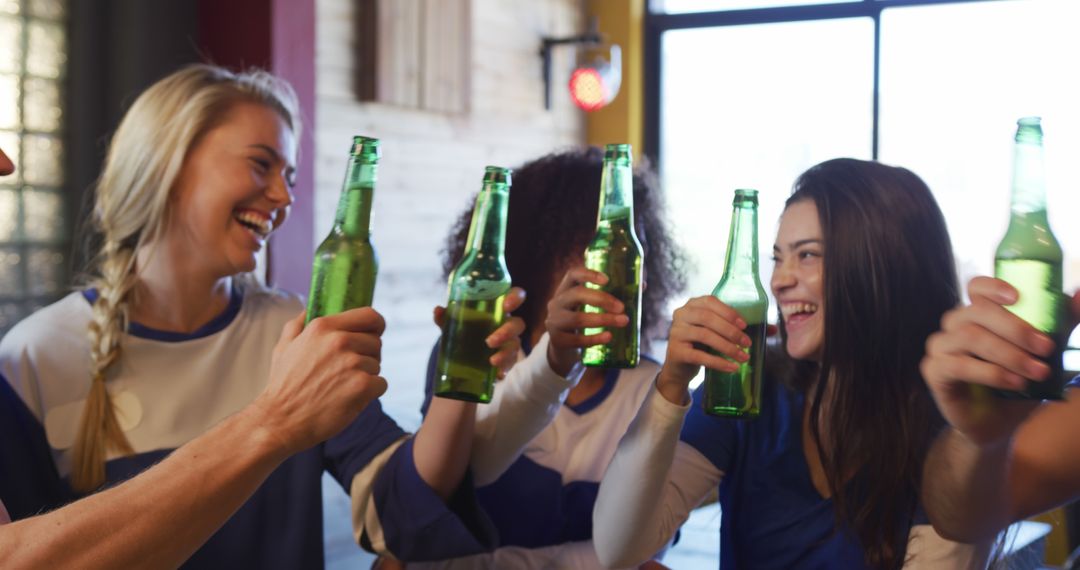 Diverse Group of Friends Toasting with Beers in Bar