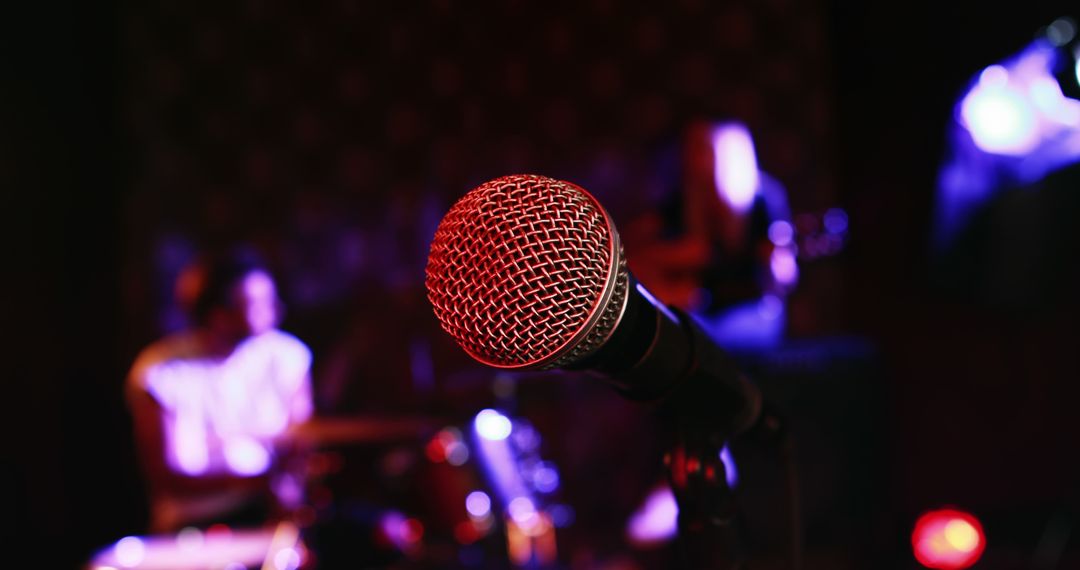 Closeup of Microphone on Stage with Live Band in Background - Free Images, Stock Photos and Pictures on Pikwizard.com