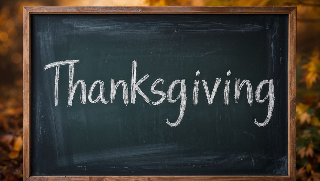 Rustic Chalkboard Displaying Thanksgiving Handwritten in Autumn Outdoor Scene