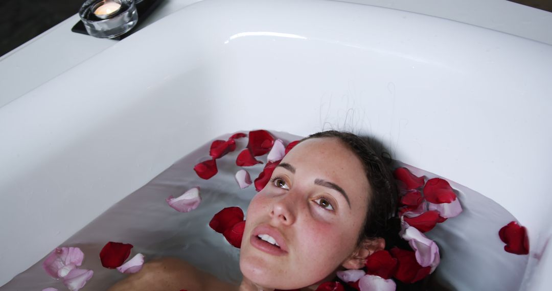 Woman Relaxing in Bathtub with Rose Petals and Candle - Free Images, Stock Photos and Pictures on Pikwizard.com