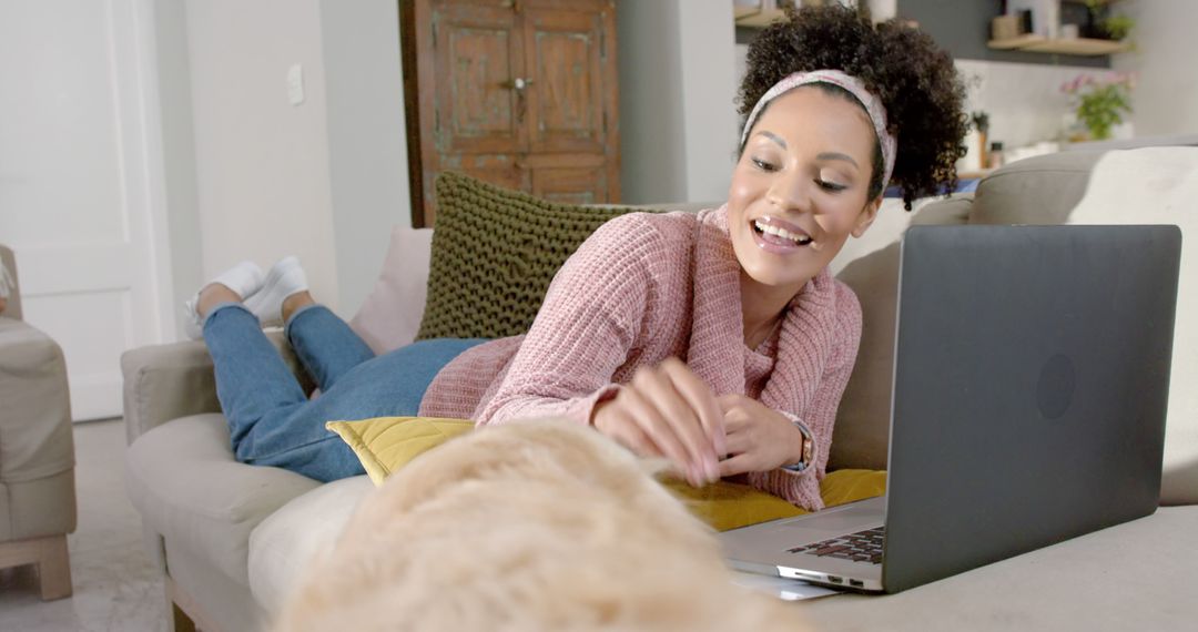 Joyful Woman Relaxing on Couch with Laptop and Dog - Free Images, Stock Photos and Pictures on Pikwizard.com