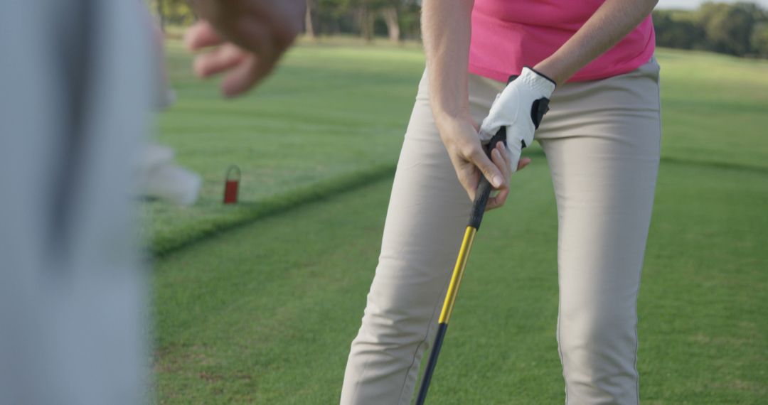 Woman Preparing to Swing Golf Club on Grass - Free Images, Stock Photos and Pictures on Pikwizard.com