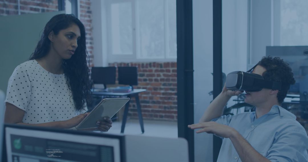 Colleagues Collaborating on Virtual Reality Technology in Modern Office