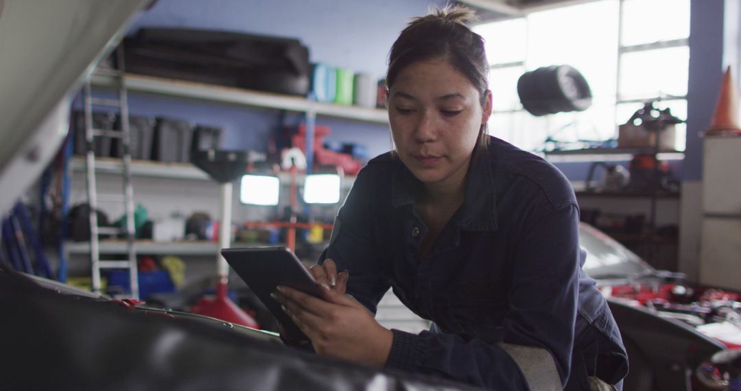 Female Mechanic Using Digital Tablet in Auto Workshop - Free Images, Stock Photos and Pictures on Pikwizard.com