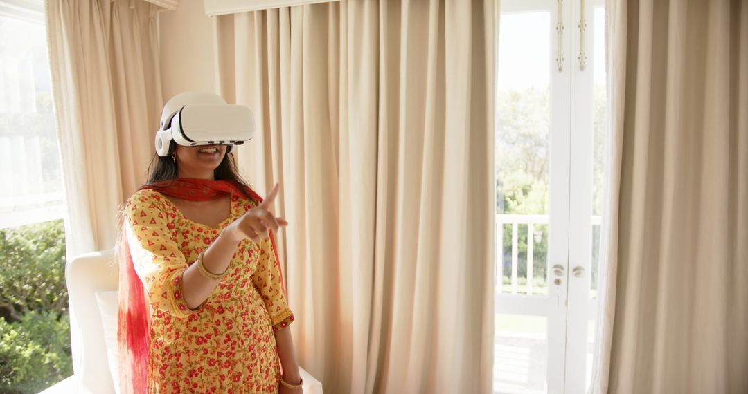 Indian Woman in Traditional Dress Exploring Virtual Reality at Home