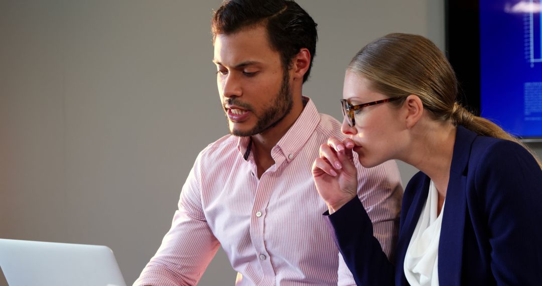 Two Business Professionals Collaborating on Laptop Task