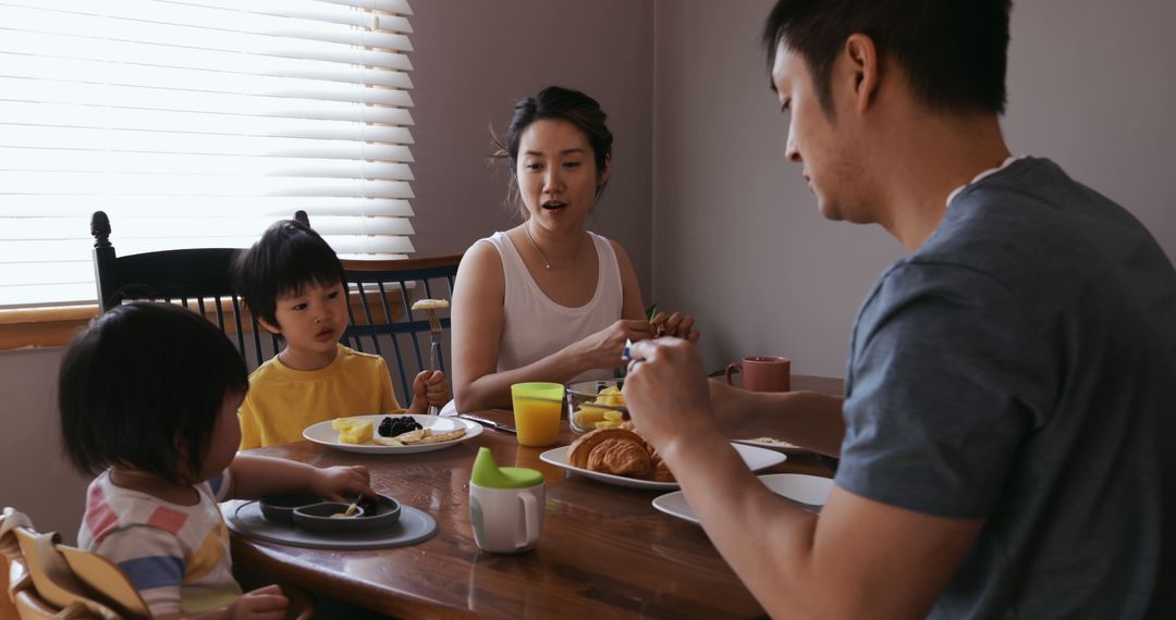 Asian Family Enjoying Casual Breakfast Together at Home in Cozy Dining Area - Free Images, Stock Photos and Pictures on Pikwizard.com